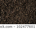 Background of black fanning or broken loose leaf tea. Close up, top view. 102477601