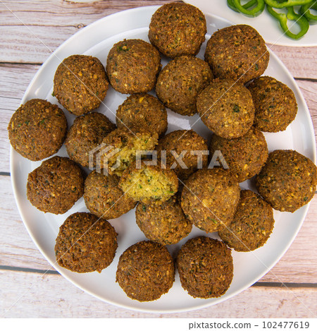 Fried falafel balls with chopped legumes and chickpeas 102477619