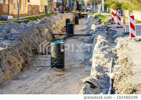 Street reconstruction with underground pipes replacement, deep trench with large plastic wells 102480299