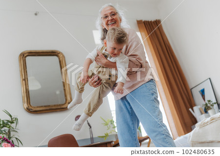 Senior woman having fun with her little grandson. Senior woman having fun with her little grandson. 102480635