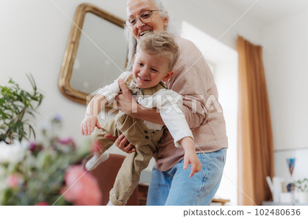 Senior woman having fun with her little grandson. Senior woman having fun with her little grandson. 102480636