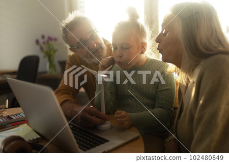 Senior couple doing homework with their granddaughter. Senior couple doing homework with their granddaughter. 102480849