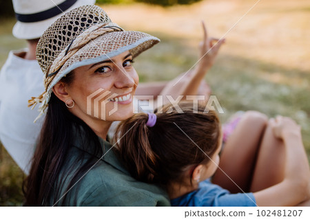 Portrait of happy, affectionate mother and daughter hugging during sunset. Portrait of happy, affectionate mother and daughter hugging during sunset. 102481207