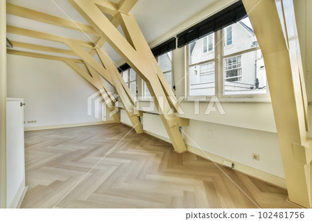 an empty room with wood flooring and wooden beams on the ceiling in this photo is taken from the inside an empty room with wood flooring and wooden beams on the ceiling in this photo is taken from the inside 102481756