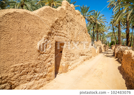 Al Ula ruined old town street with palms along the road, Saudi Arabia 102483076