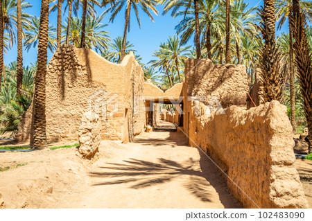 Al Ula ruined old town street with palms along the road, Saudi Arabia Al Ula ruined old town street with palms along the road, Saudi Arabia 102483090
