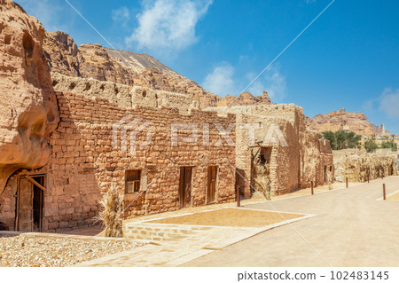 Al Ula old town street with ruined mud huts, Medina province, Saudi Arabia 102483145