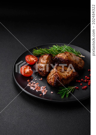 Delicious grilled meat in the form of a kebab with spices and herbs Delicious grilled meat in the form of a kebab with spices and herbs 102484322