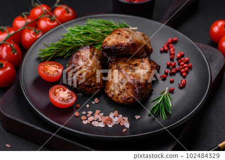 Delicious grilled meat in the form of a kebab with spices and herbs Delicious grilled meat in the form of a kebab with spices and herbs 102484329