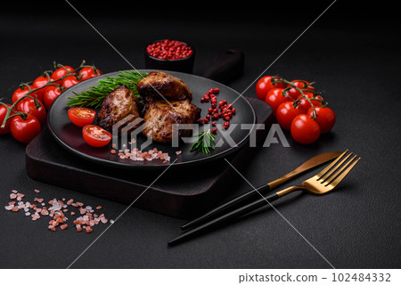 Delicious grilled meat in the form of a kebab with spices and herbs 102484332