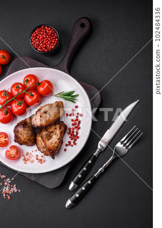Delicious grilled meat in the form of a kebab with spices and herbs Delicious grilled meat in the form of a kebab with spices and herbs 102484336