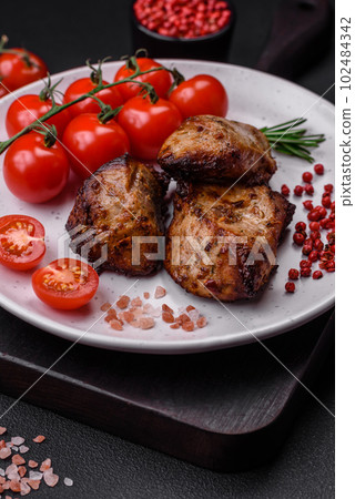 Delicious grilled meat in the form of a kebab with spices and herbs Delicious grilled meat in the form of a kebab with spices and herbs 102484342