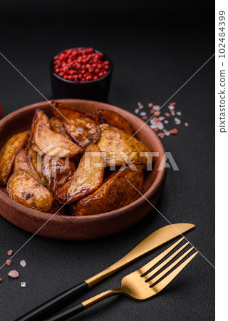 Delicious grilled potato slices with garlic, spices and herbs 102484399