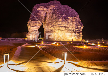 Illuminated sandstone elephant rock monolith standing in the night desert, Al Ula, Saudi Arabia Illuminated sandstone elephant rock monolith standing in the night desert, Al Ula, Saudi Arabia 102484442