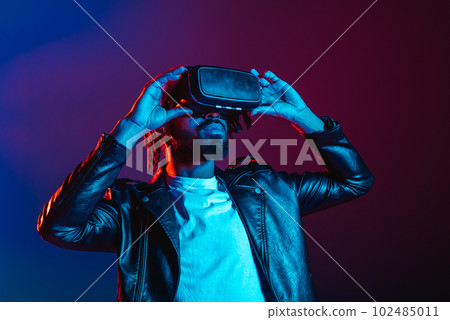 Man with VR glasses watches a 3D scene 102485011