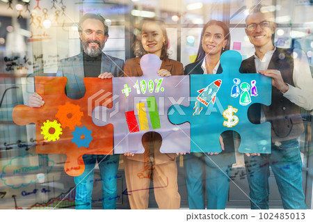 Teamwork of partners connect puzzle pieces as integration and startup 102485013