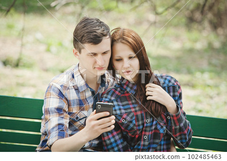 Couple looking at mobile phone 102485463