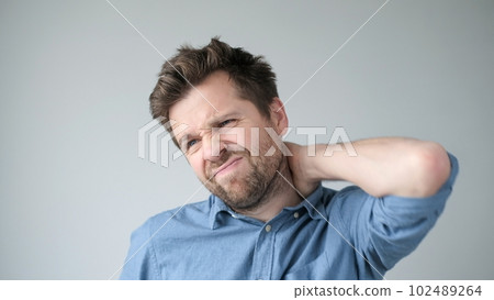 Caucasian man has neck and shoulder pain. Caucasian man has neck and shoulder pain. 102489264