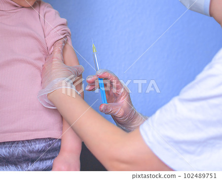 Little child is vaccinated by the doctor. Little child is vaccinated by the doctor. 102489751
