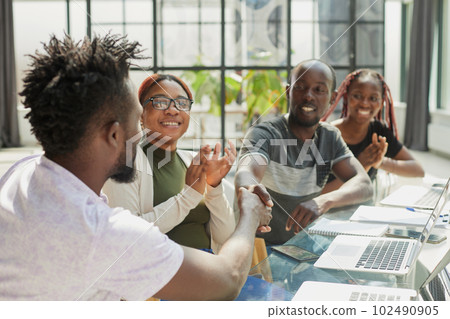 Business handshake in the office. african american team 102490905