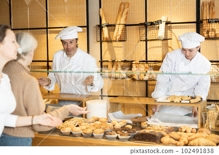 Happy male and female bakery workers showing around their workplace 102491838