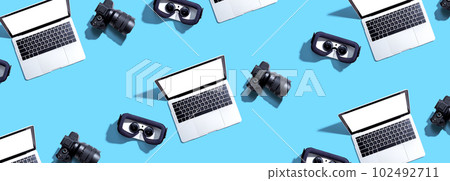 Tech gear theme with vr headset, dslr camera and laptop Tech gear theme with vr headset, dslr camera and laptop 102492711
