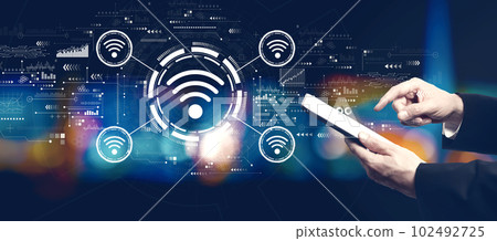 Wifi theme with businessman using a tablet computer Wifi theme with businessman using a tablet computer 102492725