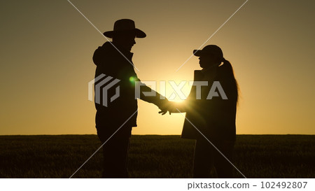 handshake silhouette. farmers businessmen shake hands with each other sunset. have deal. negotiate deal. partnerships. teamwork. Wheat field. Agriculture. farming concept. group people shaking hands handshake silhouette. farmers businessmen shake hands with each other sunset. have deal. negotiate deal. partnerships. teamwork. Wheat field. Agriculture. farming concept. group people shaking hands 102492807