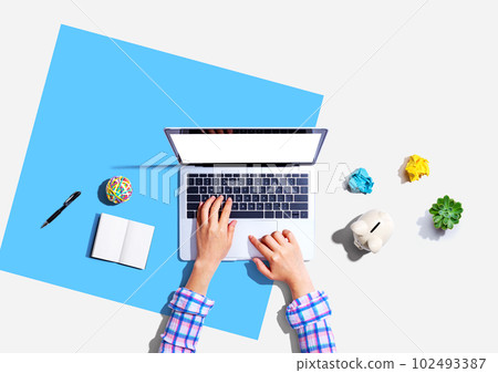 Laptop computer with a piggy bank and office objects 102493387