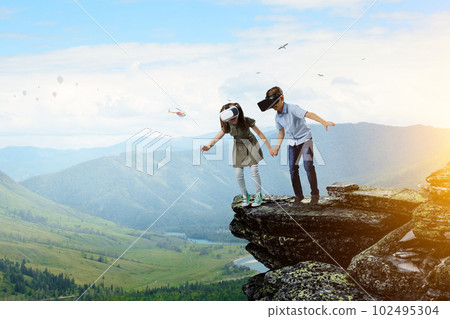 Kids wearing virtual reality goggles 102495304