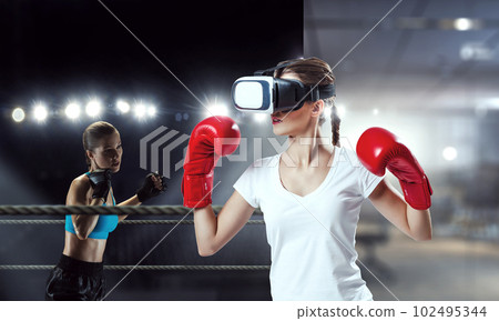 Young woman boxing in VR glasses 102495344