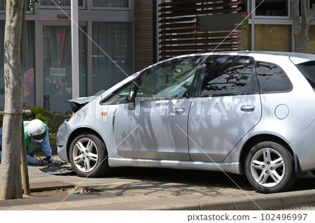 Car accident A car that runs into a sidewalk and jumps into a store 102496997
