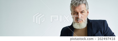 Portrait of stylish middle aged man with a beard looking at came Portrait of stylish middle aged man with a beard looking at came 102497418
