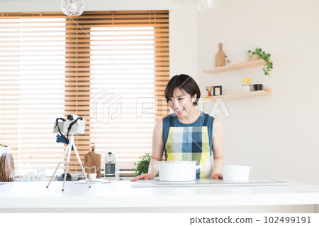 A woman who records food in a video A woman who records food in a video 102499191