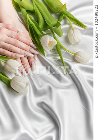 Female hand with spring nail design. Female hand with spring nail design. 102499222