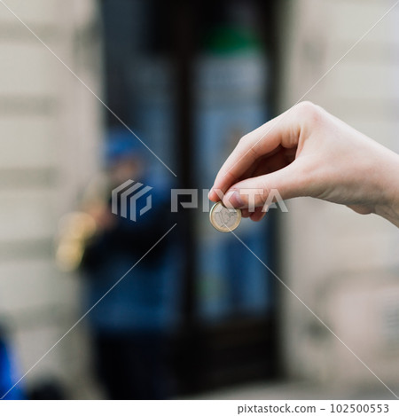 Street old performer musician plays saxofon blurred, coin in hand focused Street old performer musician plays saxofon blurred, coin in hand focused 102500553