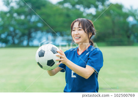 A smiling Japanese woman practicing soccer and futsal as a hobby A smiling Japanese woman practicing soccer and futsal as a hobby 102500769