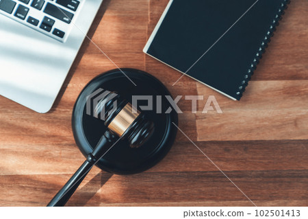 Black wooden gavel with laptop at office as justice and legal. equility 102501413