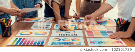 Graphic designer brainstorming logo and graphic arts at workshop. Scrutinize 102501729