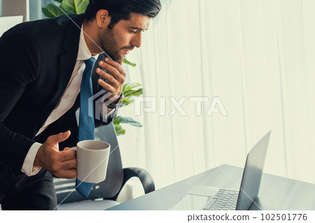 Professional businessman at modern office desk with confused expression. fervent Professional businessman at modern office desk with confused expression. fervent 102501776