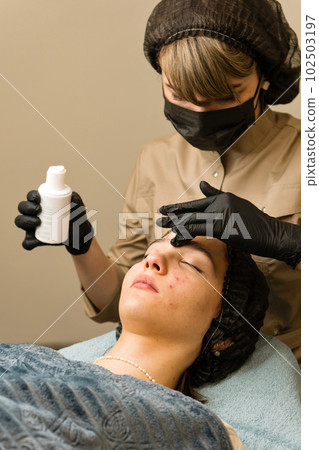 Dermatologist apply serum for face on teen skin Dermatologist apply serum for face on teen skin 102503197