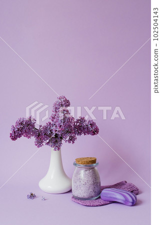 Lilac spa. Sea salt, washcloth mitten, lilac flowers, sea salt handmade soap. Natural herbal cosmetics with flowers on a light background. Relaxation concept. Cosmetic procedures. Copy space. Lilac spa. Sea salt, washcloth mitten, lilac flowers, sea salt handmade soap. Natural herbal cosmetics with flowers on a light background. Relaxation concept. Cosmetic procedures. Copy space. 102504143