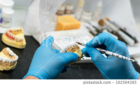 Dental prosthesis work. Teeth painting. Dental prosthesis work. Teeth painting. 102504165