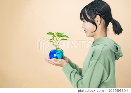Girl holding a flowerpot with the earth drawn Environmental protection image Girl holding a flowerpot with the earth drawn Environmental protection image 102504504