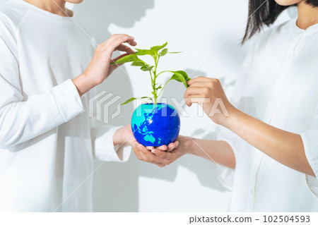 Children holding flower pots with the earth drawn Environmental protection image 102504593