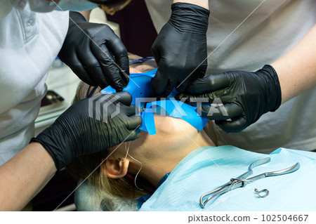 Isolate patient's teeth with rubber pad. Isolate patient's teeth with rubber pad. 102504667