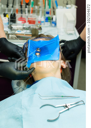 Isolate patient's teeth with rubber pad. Isolate patient's teeth with rubber pad. 102504672