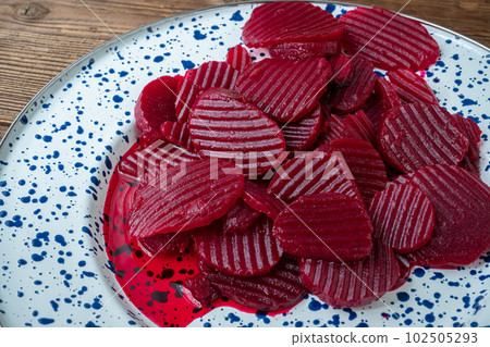 Slices of pickled red beets on a plate 102505293
