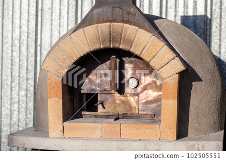 Cooking real pizza in a brick oven. Wood and fire are burning Cooking real pizza in a brick oven. Wood and fire are burning 102505551