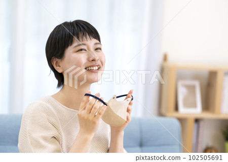 Young woman removing the mask 102505691